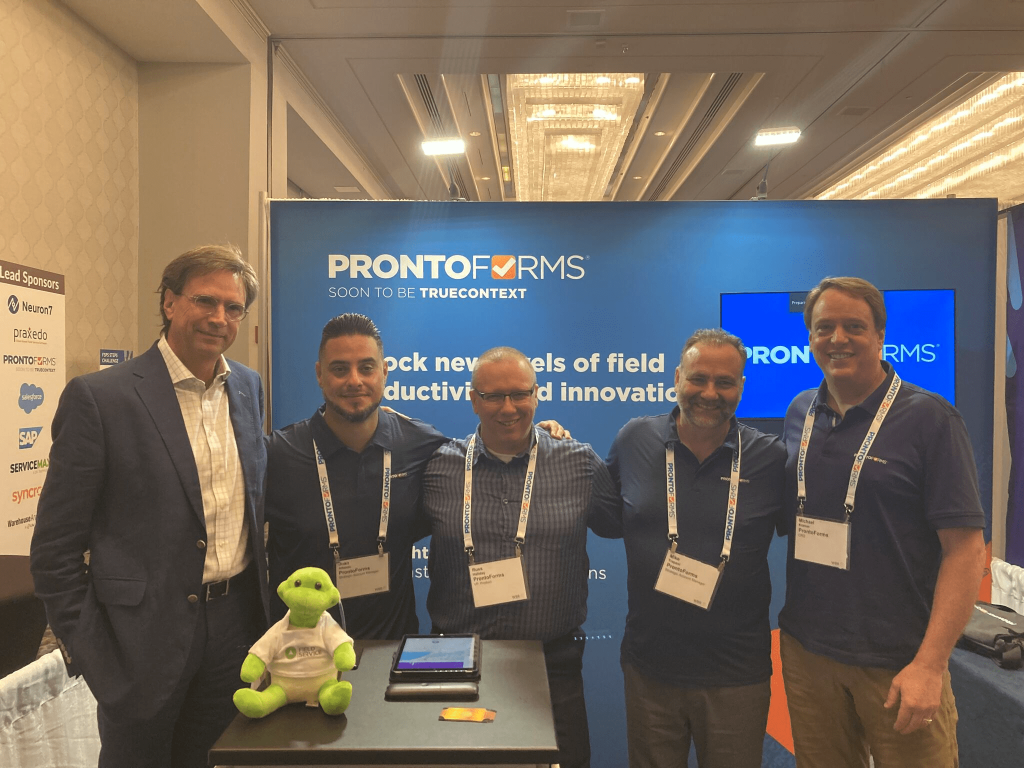 Alvaro Pombo (left), Mike Kramer (right), and other ProntoForms representatives at Field Service Hilton Head 2023